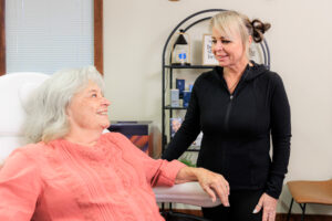 A patient and a provider smile during a treatment at our wellness center near Hayden.