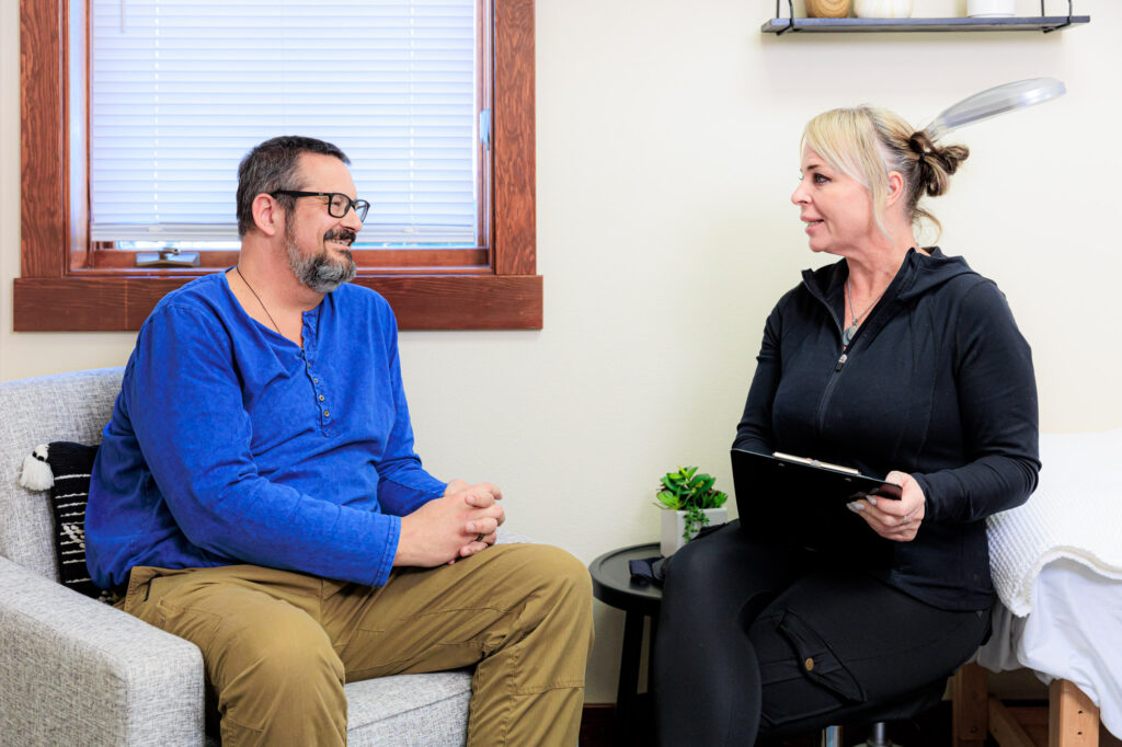 A provider and a patient smile during a consultation for holistic medicine in Coeur d’Alene.