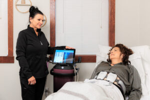 A woman lies back while a provider administers diastasis recti repair in Coeur d’Alene.