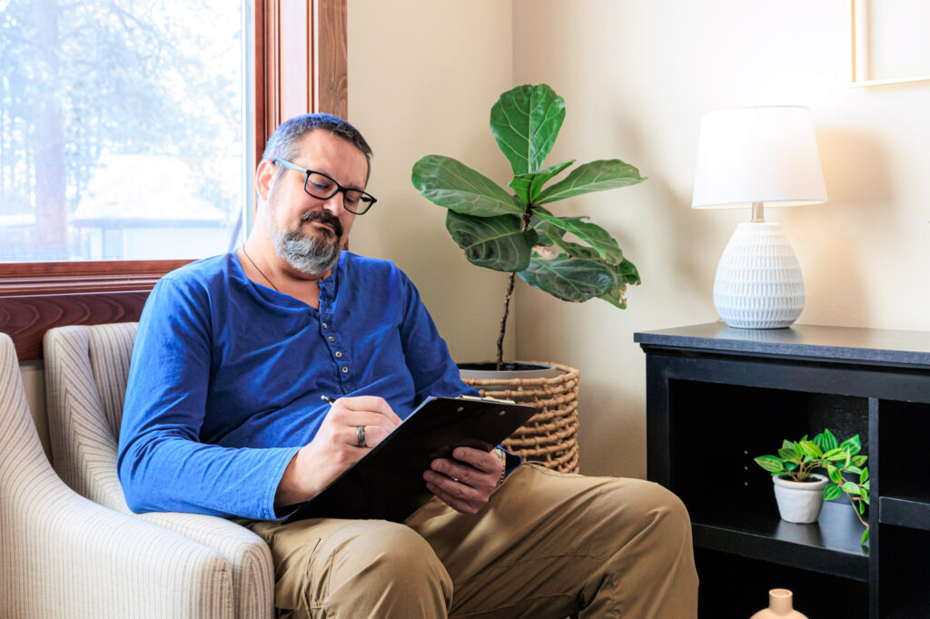 A patient sits and reads about TRT in Coeur d’Alene