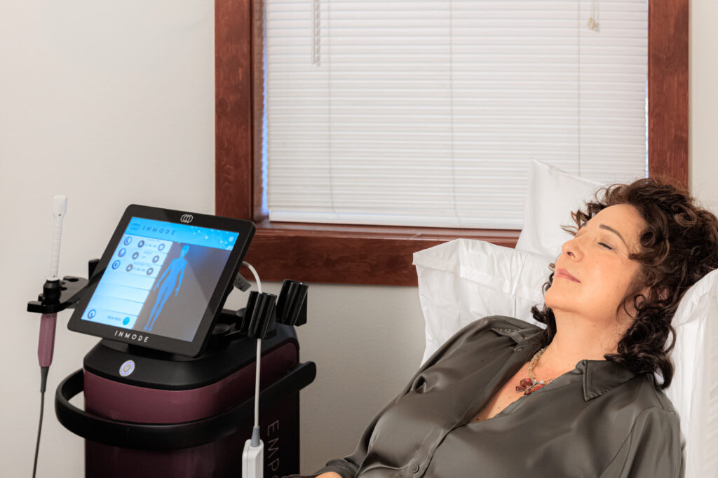 A woman with curly hair lays back as she receives a FormaV treatment in Coeur d’Alene.